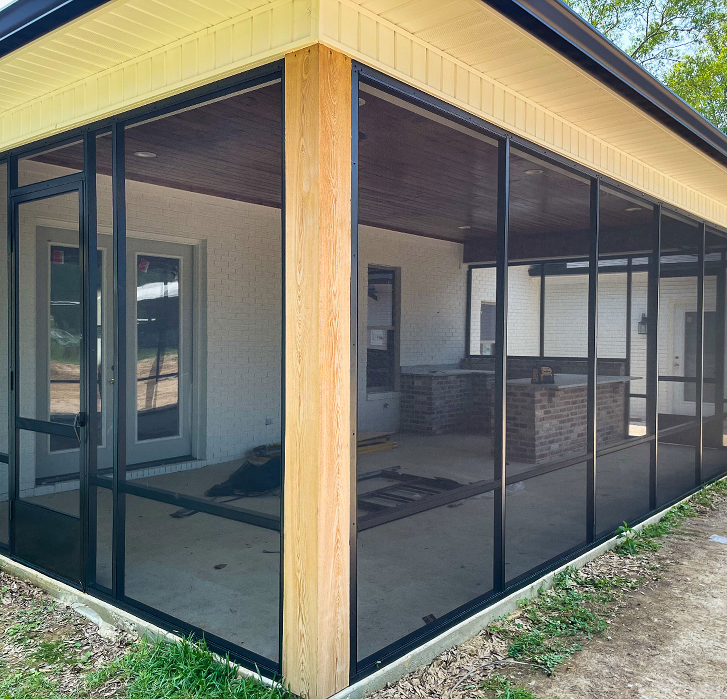 black-aluminum-screen-enclosure-custom-frame-mississippi Black aluminum screen enclosure with custom wood framing on a Mississippi home patio